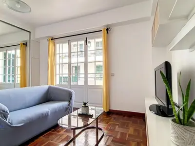a living room with a blue couch and a glass table at Apartment Wohnung in Funchal- in der Nähe von Farmers Market by Interhome in Funchal