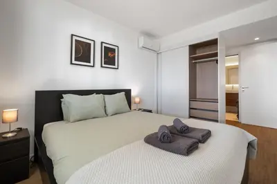 a bedroom with a large bed with two towels on it at Oceanfront Bliss - Atlantico residences in Câmara de Lobos