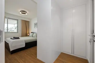 a bedroom with a bed and a sliding glass door at Oceanfront Bliss - Atlantico residences in Câmara de Lobos