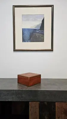 a wooden box sitting on a table with a picture at Downtown Funchal Bohemian Charm in Funchal