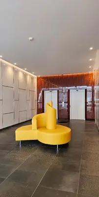 a yellow couch in the middle of a room at Downtown Funchal Bohemian Charm in Funchal