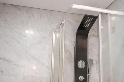 a shower with a glass door in a bathroom at Madeira Holidays Studio by Amazing Madeira in Funchal