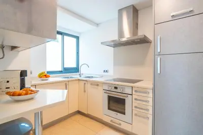 a kitchen with a sink and a refrigerator at Madeira Holidays Studio by Amazing Madeira in Funchal