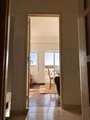 an open door to a living room with a view of a room at Casinha Menta in Carrapateira