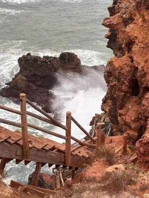 a view of the ocean with waves crashing on the rocks at Casinha Menta in Carrapateira