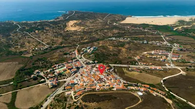 an aerial view of a village next to the beach at Casinha Menta in Carrapateira