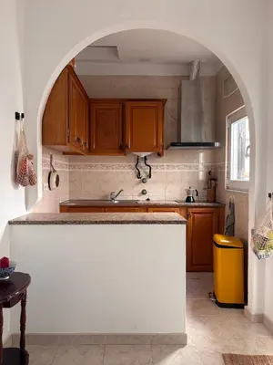 a kitchen with an archway in the middle of it at Casinha Menta in Carrapateira