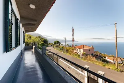 a balcony of a house with a view of the ocean at Villa Jardim by GALMI in São Vicente