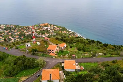 an aerial view of a small village on a hill next to the ocean at Villa Jardim by GALMI in São Vicente