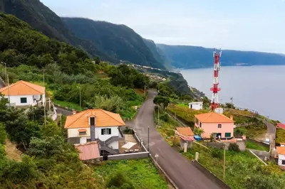 a winding road in a village next to a body of water at Villa Jardim by GALMI in São Vicente