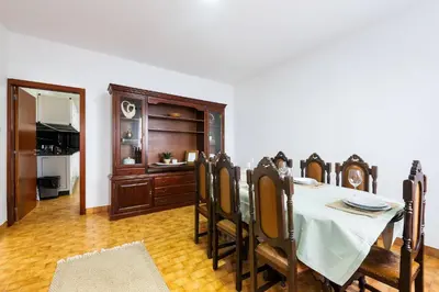 a dining room with a table and some chairs at Villa Jardim by GALMI in São Vicente