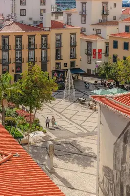 an overhead view of a courtyard in a city with buildings at Angie's House in Funchal