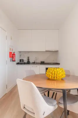 a kitchen with a table with a bowl of fruit on it at Angie's House in Funchal