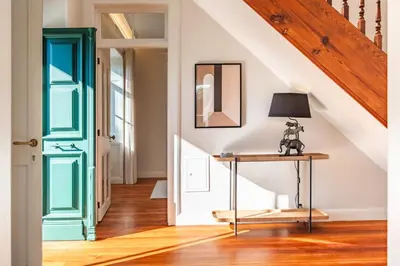a room with a green door and a table with a lamp at Quintinha de São Martinho - Villa & Lux in Funchal