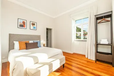 a white bedroom with a bed and a window at Quintinha de São Martinho - Villa & Lux in Funchal