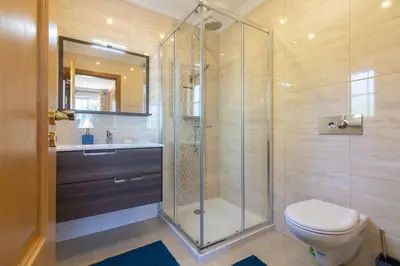 a bathroom with a shower and a toilet and a sink at Casa Magnólia in Luz