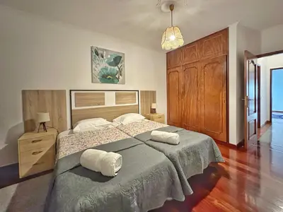 a bedroom with a large bed with two towels on it at Blue Horizon House in Funchal