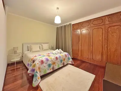 a bedroom with a bed and a wooden cabinet at Blue Horizon House in Funchal