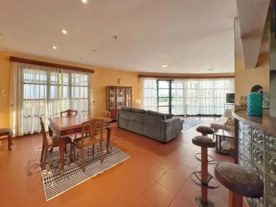 a living room with a table and a couch at Blue Horizon House in Funchal