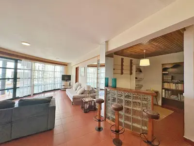 a large living room with couches and a fireplace at Blue Horizon House in Funchal