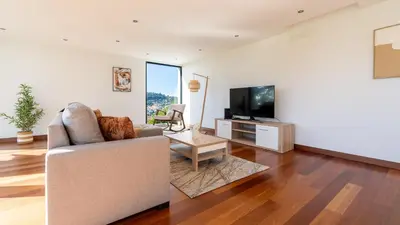 a living room with a couch and a tv at Villa Jamboeiro by LovelyStay in Funchal