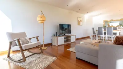 a living room with a couch and a tv at Villa Jamboeiro by LovelyStay in Funchal