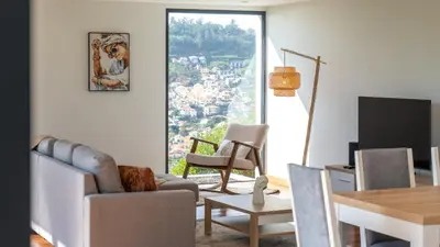 a living room with a couch and a table at Villa Jamboeiro by LovelyStay in Funchal