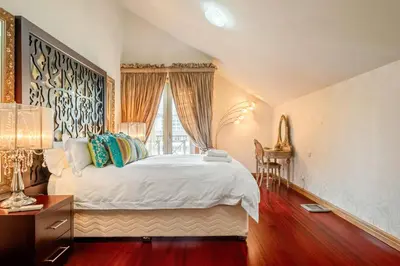 a bedroom with a large white bed and a window at Cliff View Apartment - By Wehost in Funchal