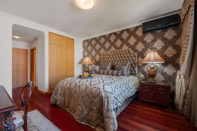 a bedroom with a large bed with two lamps on it at Cliff View Apartment - By Wehost in Funchal