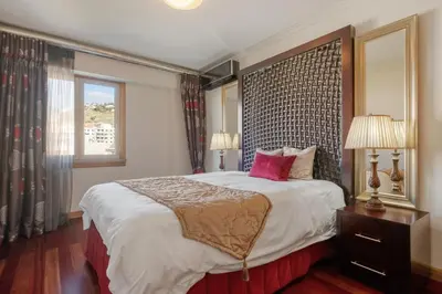 a bedroom with a large bed and a window at Cliff View Apartment - By Wehost in Funchal