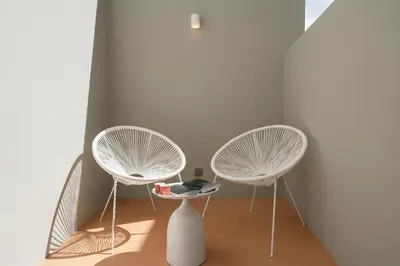 two white chairs and a table in a room at With patio in Funchal city centre - AL'gria I in Funchal