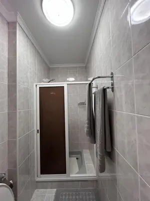 a bathroom with a shower with a mirror and a toilet at Casa Do Arco - Machico Centre with Private Balconies and Parking in Machico