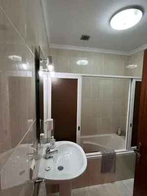 a bathroom with a sink and a bath tub at Casa Do Arco - Machico Centre with Private Balconies and Parking in Machico
