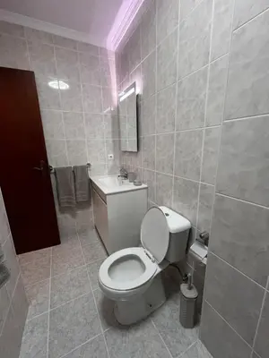 a bathroom with a white toilet and a sink at Casa Do Arco - Machico Centre with Private Balconies and Parking in Machico