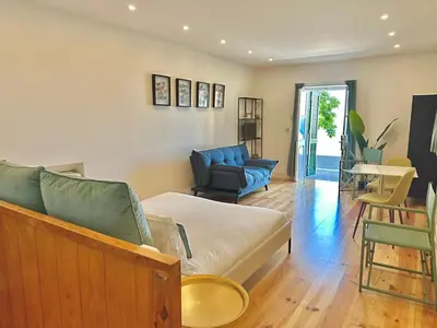 a living room with a couch and a chair at Espada Preta Apartments in Câmara de Lobos