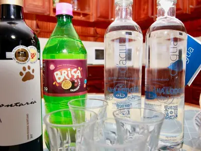 three bottles of wine and glasses on a counter at Holiday Home Villa Lapa in Câmara de Lobos by Interhome in Câmara de Lobos
