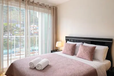 a bedroom with a large bed with towels on it at Penthouse Montanha-Mar in Machico