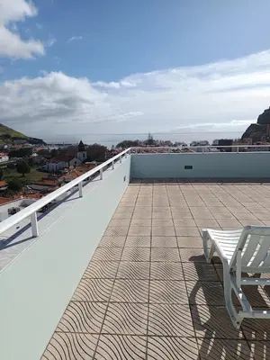a white bench sitting on top of a roof at Penthouse Montanha-Mar in Machico