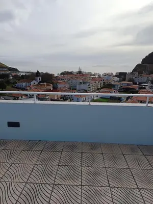 a blue bench sitting on top of a building at Penthouse Montanha-Mar in Machico