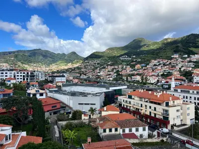 a city with buildings and mountains in the background at Penthouse Montanha-Mar in Machico