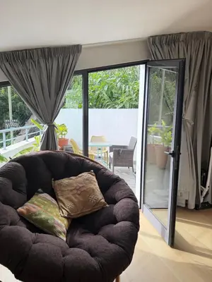 a couch with two pillows in a living room at Cozy Studio & Patio in Funchal in Funchal
