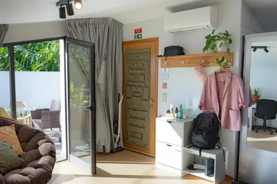 a living room with a sliding glass door at Cozy Studio & Patio in Funchal in Funchal