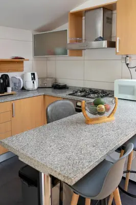 a kitchen with a counter with a tray of food on it at Cozy Studio & Patio in Funchal in Funchal