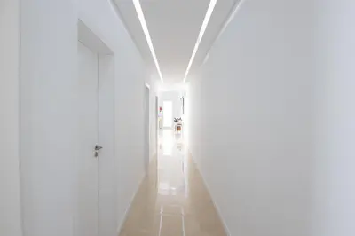 a hallway with white walls and a white door at Bela Vista - pool in Arco da Calheta