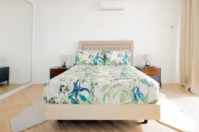 a bedroom with a bed and two night stands at Bela Vista - pool in Arco da Calheta