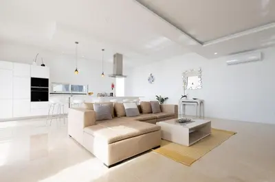 a white living room with a couch and a table at Bela Vista - pool in Arco da Calheta