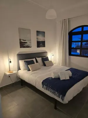 a bedroom with a large bed with two pillows at Sagres Escape Near Mareta Beach in Sagres