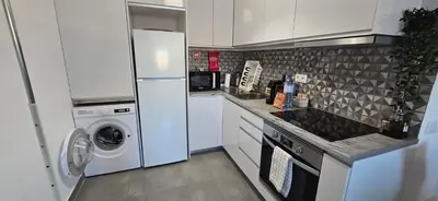 a kitchen with a refrigerator and a washer and dryer at Sagres Escape Near Mareta Beach in Sagres