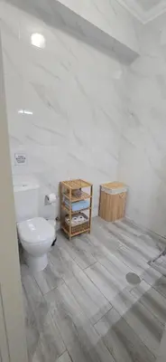 a white bathroom with a toilet and a wooden table at Sagres Escape Near Mareta Beach in Sagres