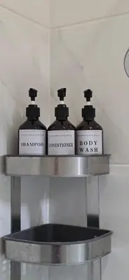three bottles of soap on a shelf in a bathroom at Sagres Escape Near Mareta Beach in Sagres